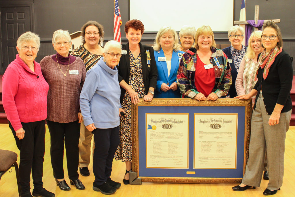 Women pose with the framed chapter charter